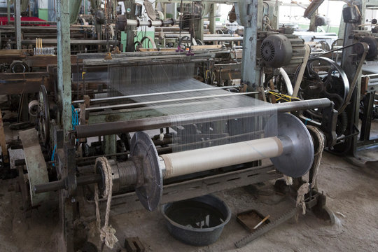 Old loom in a silk factory, close-up. Margilan, Uzbekistan