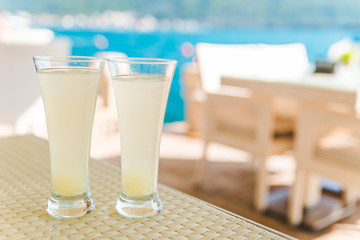 two glasses of juice on cafe table
