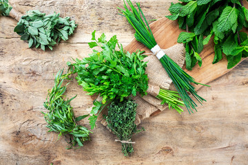 fresh aromatic herbs from above on old wood  background