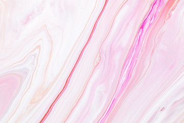 Fluid art texture. Abstract background with iridescent paint effect. Liquid acrylic picture that flows and splashes. Mixed paints for background or poster. Pink, white and beige overflowing colors