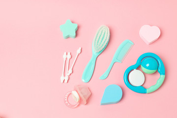 Baby care accessories on pink background flat lay