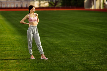 Attractive young fitness woman in sportswear traning outdoor