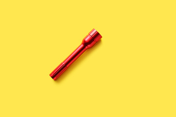 Modern flashlight on color background