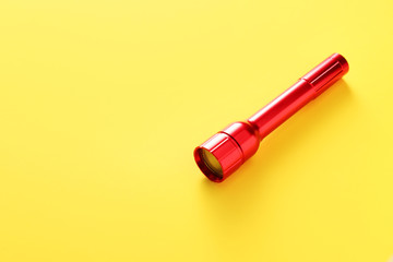 Modern flashlight on color background
