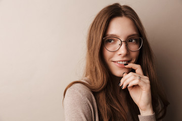 Photo of young happy woman in eyeglasses smiling and looking aside