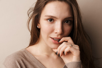 Photo of young beautiful woman posing and looking at camera