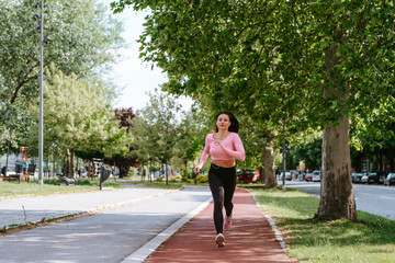 Fototapeta premium A beautiful young caucasian girl is exercising in nature