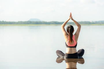 Yoga woman sitting zen and meditation for workout healthy life in sunrise morning. Young girl or people pose balance body vital  and exercise in nature background. Health care and Lifestyle Concept