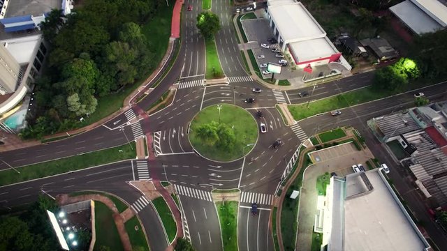 Traffic of cars on a roundabout at night. Speed up video at Mato Grosso avenue, Campo Grande MS, Brazil.