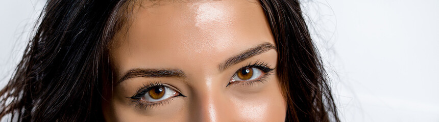 Obraz premium close-up photo of woman eye with eyeliner makeup on white background.