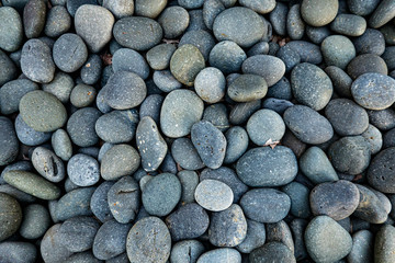Fototapeta na wymiar Textured pebbles background in blue hues