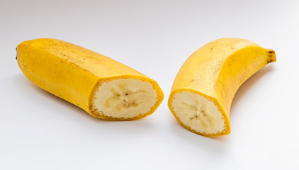 slices of a yellow banana in a cut on a white background macro shot