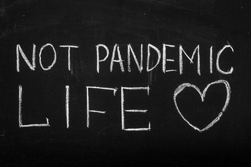 Fototapeta premium Chalkboard text message Not pandemic life. After coronavirus outbreak.