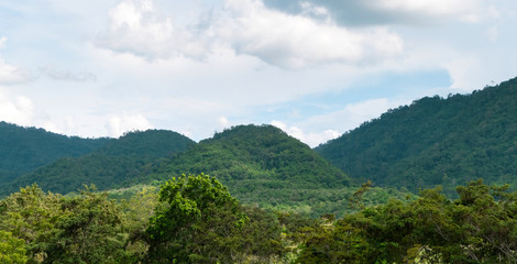 Naklejka premium Green mountains and beautiful sky clouds under blue sky. Outdoor landscape natural background.