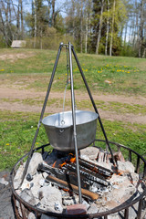 City Tuja, Latvia. Food is prepared outside. Fireplace and kettle.