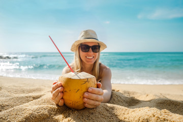 Happy Young Tourist  Smiling Caucasian Woman in hat with coconut