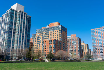 Fototapeta na wymiar Modern Residential Skyscrapers near a Park during Spring on Roosevelt Island in New York City