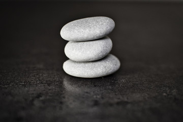 Fototapeta na wymiar zen stones on black background