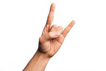 Hand of caucasian young man showing fingers over isolated white background gesturing rock and roll...