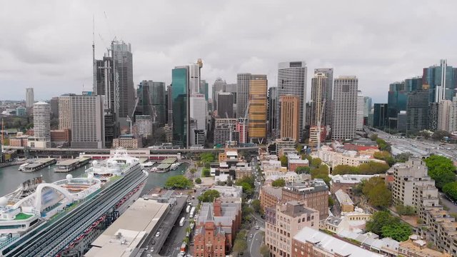 View from above on Sydney city centre. In the frame skyscrapers, port, cruise liner and bay.