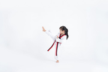 Asian kid Taekwondo kicking in white studio © torwaiphoto