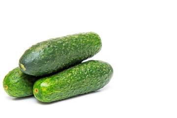 Three cucumbers on a white background