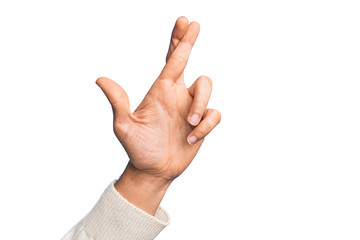 Hand of caucasian young man showing fingers over isolated white background gesturing fingers crossed, superstition and lucky gesture, lucky and hope expression - obrazy, fototapety, plakaty
