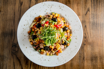Tun salad with olives, corn and rocket