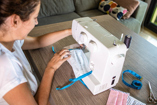 Woman Making Face Masks With A Sewing Machine At Home