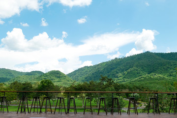 Fototapeta na wymiar Wooden table and mountain landscape scenic of coffee shop at countryside.