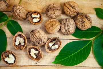 Walnuts and leaves on a  table.