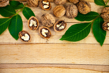 Walnuts and leaves on a  table.