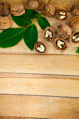 Walnuts and leaves on a  table.