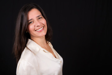 Brunette woman smile with black background in photo studio