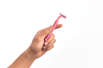 Hand of caucasian young man holding pink disposible razor over isolated white background