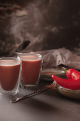 Two glasses of hot coffee. Cocoa with marshmallow. Fresh steamed coffee. Coffee with spices. Red pepper. Dark background