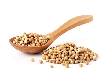 Pile of Coriander seeds with wooden spoon isolated on white background