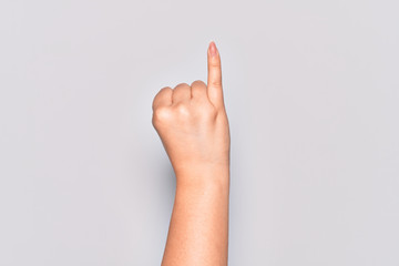 Hand of caucasian young woman showing little finger as pinky promise commitment, number one