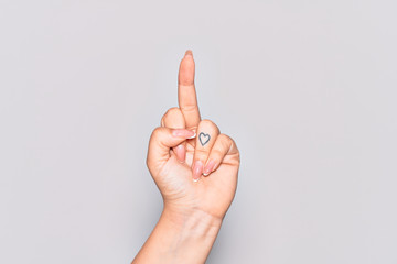 Hand of caucasian young woman showing provocative and rude gesture doing fuck you symbol with...