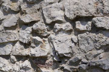 Stone wall, large gray stones, civil and industrial construction.