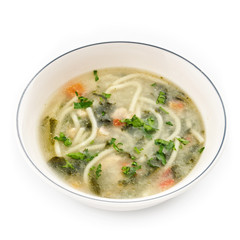 Noodle soup with chicken broth, parsley and carrots.