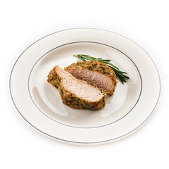 A piece of roast pork with rosemary.