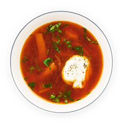 Beetroot soup - Traditional Ukrainian or Russian borscht with sour cream in a white bowl.