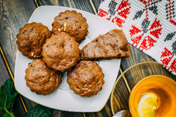 homemade cakes, chocolate muffins with mint and tea with lemon