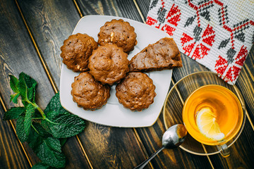 homemade cakes, chocolate muffins with mint and tea with lemon