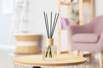 Reed diffuser on table in room