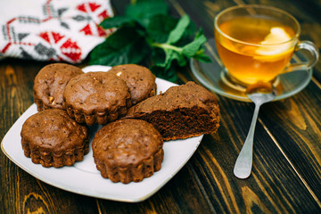 homemade cakes, chocolate muffins with mint and tea with lemon