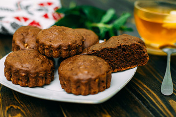 homemade cakes, chocolate muffins with mint and tea with lemon