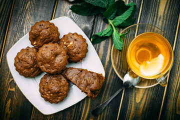 homemade cakes, chocolate muffins with mint and tea with lemon