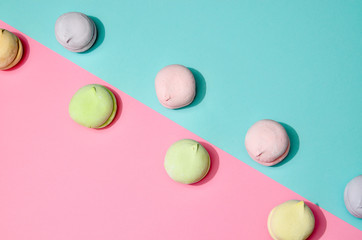 Top view of pastel colored marshmallow on a blue pink background. Minimalism photo for your design